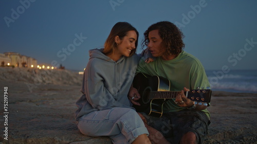 Smiling teenagers enjoying guitar music evening zoom on. Musician man singing