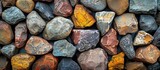 A collection of vibrant rocks stacked closely together, showcasing a range of colors and textures.