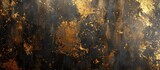 A painting of gold and black colors on a textured wall creating a striking contrast. The gold and black blend in a grungy style, adding depth to the artwork.