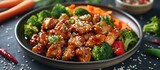 A plate filled with savory teriyaki chicken, broccoli, and carrots.