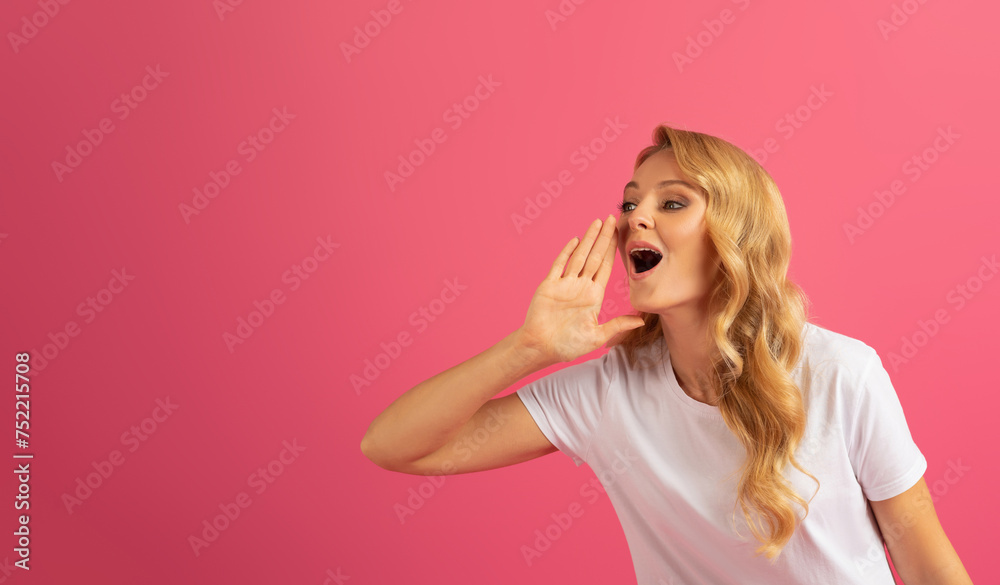 blonde woman shouting announcing special offer against pink background blonde woman shouting announcing special offer against pink background