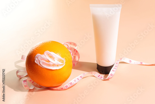 Anti cellulite concept, anticellulite cosmetic bottle mockup, smash and orange fruit photo