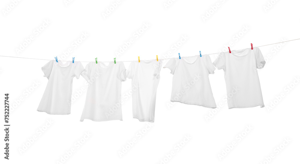Many t-shirts drying on washing line isolated on white, low angle view Many t-shirts drying on washing line isolated on white, low angle view