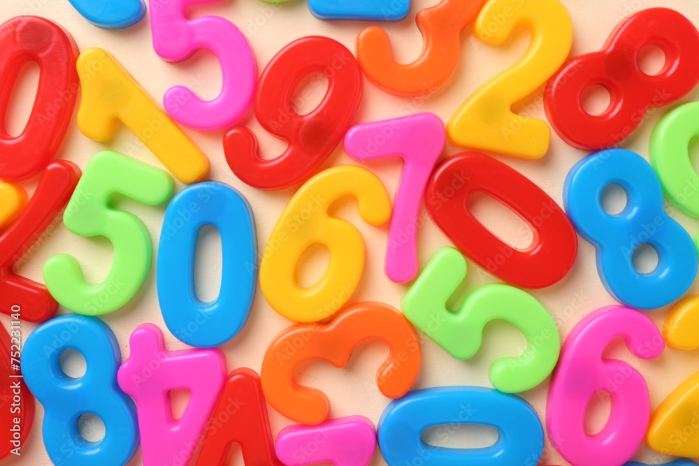 Fototapeta premium Colorful numbers on beige background, top view
