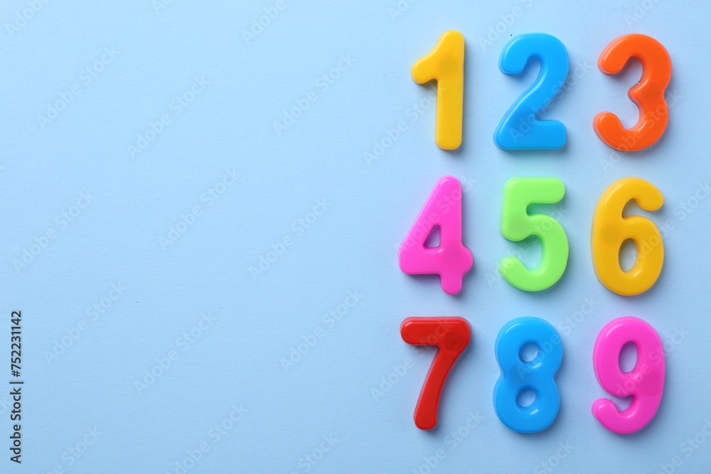 Obraz premium Colorful numbers on blue background, flat lay. Space for text