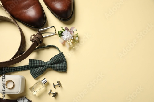 Wedding stuff. Flat lay composition with stylish boutonniere on yellow background, space for text