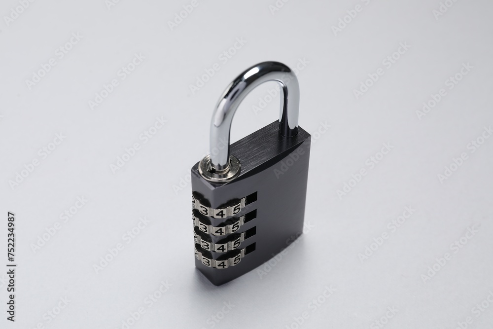 One steel combination padlock on grey background, closeup One steel combination padlock on grey background, closeup