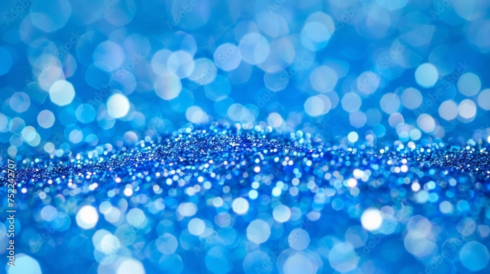 Abstract background of sparkling blue bokeh lights with a soft focus, depicting a dreamy, festive mood. Abstract background of sparkling blue bokeh lights with a soft focus, depicting a dreamy, festive mood.