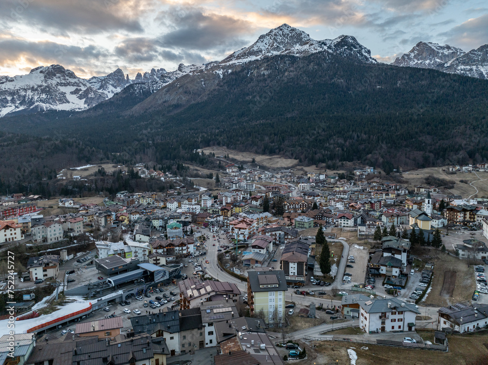 Aerial drone view of Andalo town with mountains background in winter. Snow covered Italian Dolomites at winter. Ski resort Paganella Andalo, Trentino-Alto Adige, Italy Italian Dolomites Pagnella.