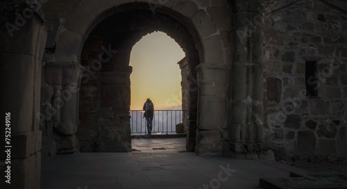 one tourist on a balcony in an old castle in Georgia