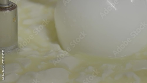 Cheese making process, separating whey from milk, closeup