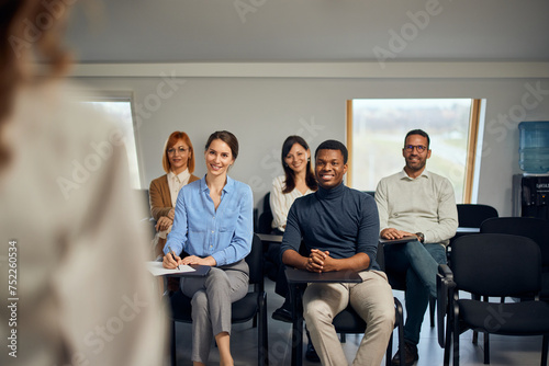 Fototapeta Naklejka Na Ścianę i Meble -  Group of people having a meeting with their female boss, sitting and listening to her.