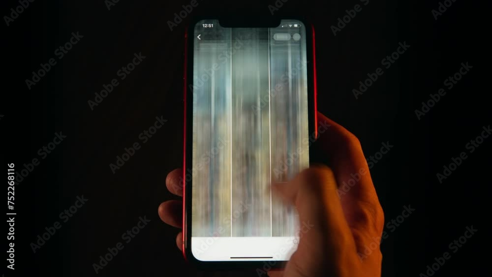 Close-up time-lapse of male hand scrolling social networks on smartphone screen, network scroll mobile phone screen at night, blurred fast motion, pov cellphone scrolling apps surf internet web pages