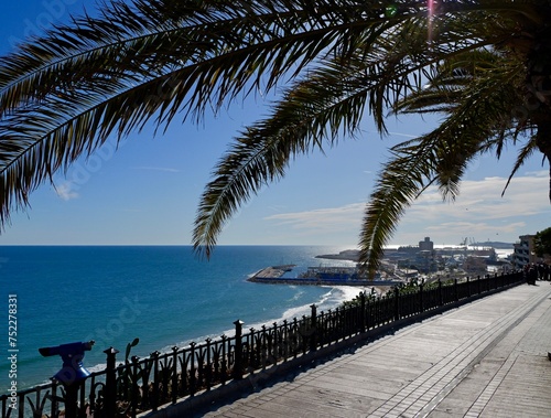 View of beach with palm trees and sea from Mediterranean Balcony (Balcó del Mediterrani), Tarragona, Mediterranean sea cost of Spain