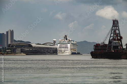 Moder mega cruiseship cruise ship liner Explorer with Kai Tak terminal and Victoria Harbor city skyline in Hong Kong Hongkong, China photo