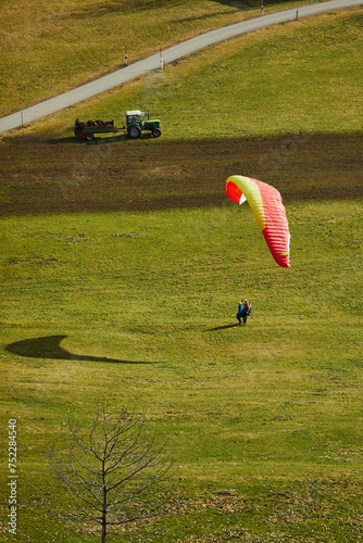 paraglider in the field, paragliding tandem landing