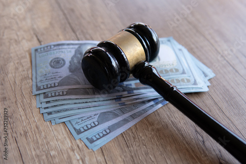 Closeup image of gavel and money. Fine, penalty, bribe concept. photo