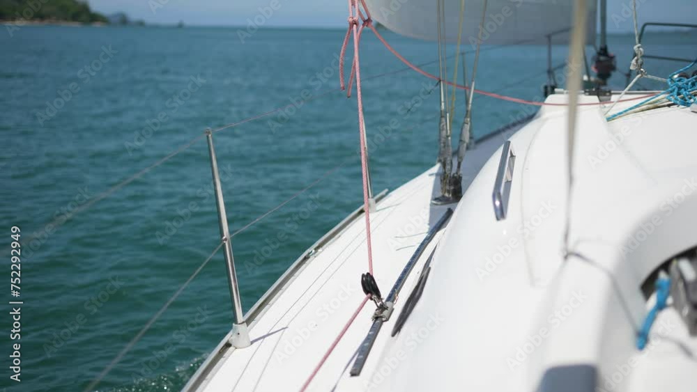 sailing yacht with spread sails splitting the sea waves and an island on the horizon.sailing yacht boat driving on the ocean on a sunny day Bow of the boat cutting through the sea. Summer sailing yacht with spread sails splitting the sea waves and an island on the horizon.sailing yacht boat driving on the ocean on a sunny day Bow of the boat cutting through the sea. Summer