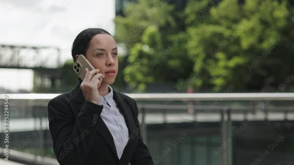 Ethnic Business Girl Talking on Phone with Office Staff Outdoors. Serious Lady Boss Decides Matters on Smartphone Outside. People and Technology Concept Ethnic Business Girl Talking on Phone with Office Staff Outdoors. Serious Lady Boss Decides Matters on Smartphone Outside. People and Technology Concept