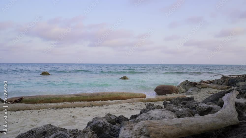Isla Mucura, Colombia. Sea and waves by the coast. Blue and clear sky and water. Rocks on the shore. Isla Mucura, Colombia. Sea and waves by the coast. Blue and clear sky and water. Rocks on the shore.