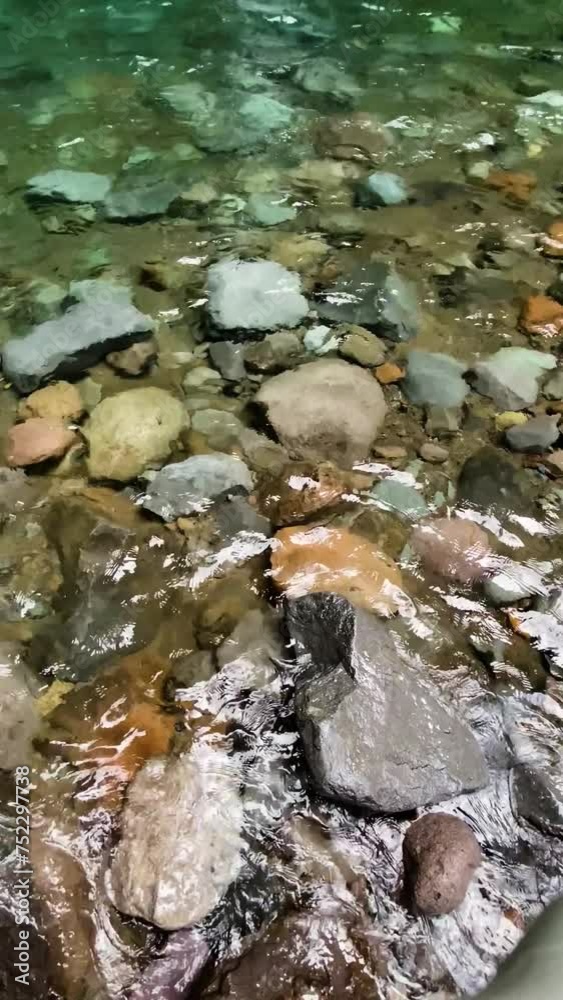 Clear freshwater over the rocks in tropical river. Vertical view. Clear freshwater over the rocks in tropical river. Vertical view.
