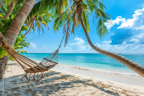 Hammock on the beach with palm trees and turquoise sea