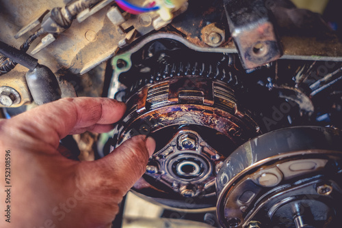 Motorcycle mechanics are assembling the motorcycle engine clutch assembly and maintenance.	