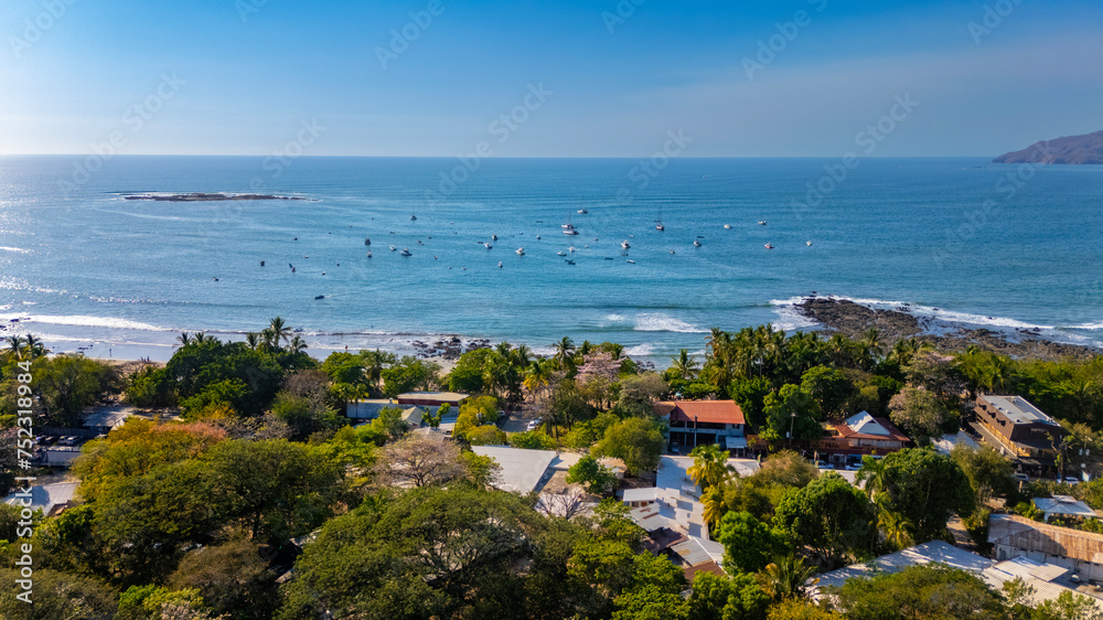 Tamarindo, Costa Rica Daytime aerial with beachfront buildings and boats in Tamarindo bay