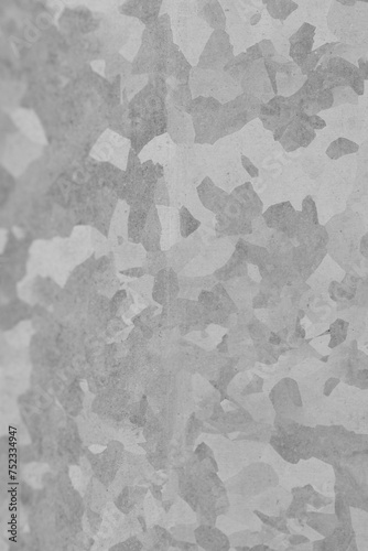 Metallic zinc background. Mottled, camouflage grey texture.