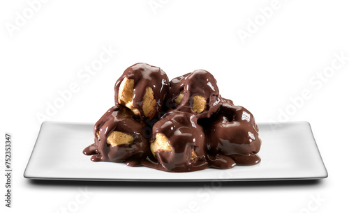white rectangular plate with profiteroles, cream puffs covered in chocolate