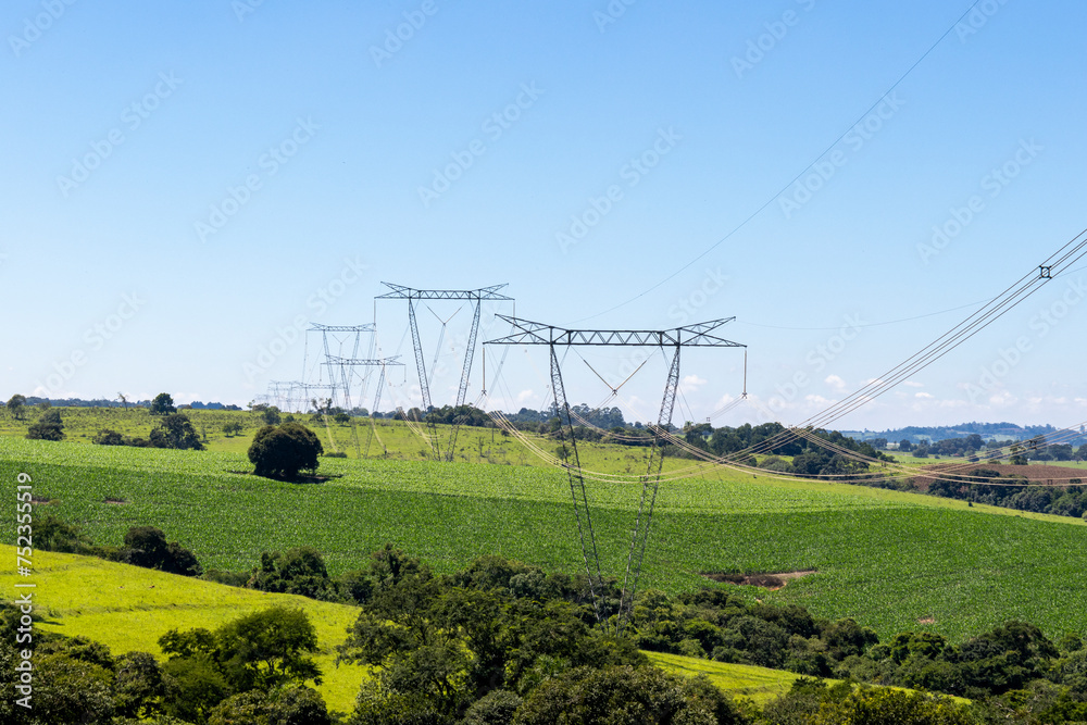 High voltage power towers on a farm