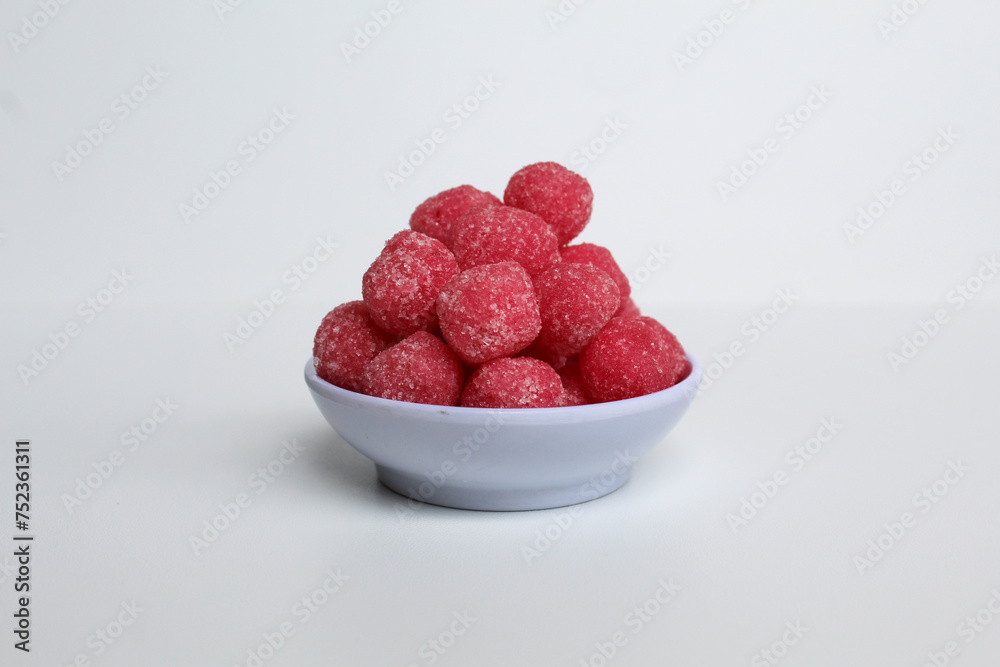 Soursop candy, in pink color and ball shaped, coated by sugar. Isolated on white background Soursop candy, in pink color and ball shaped, coated by sugar. Isolated on white background