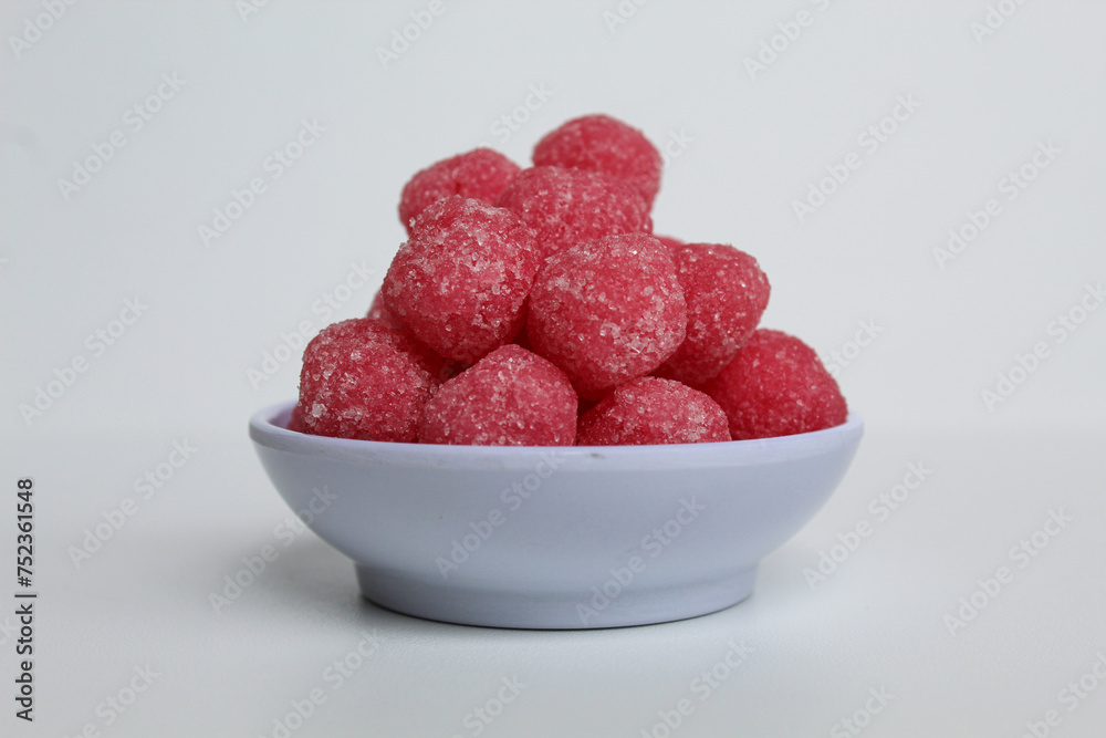 Soursop candy, in pink color and ball shaped, coated by sugar. Isolated on white background Soursop candy, in pink color and ball shaped, coated by sugar. Isolated on white background