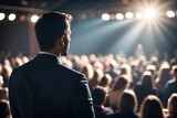 motivational speaker standing on stage in front of audience for motivation speech