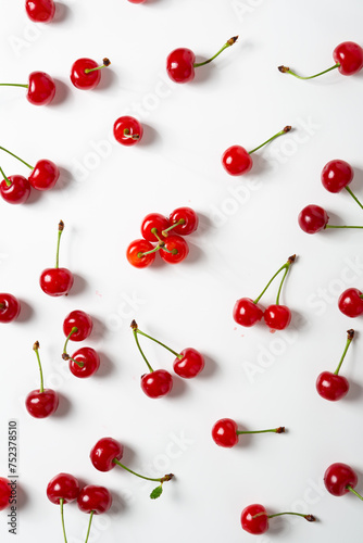 ripe red cherries close up on light surface summer background