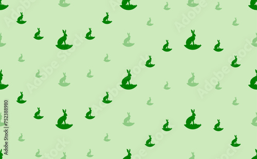 Seamless pattern of large and small green hare symbols. The elements are arranged in a wavy. Vector illustration on light green background