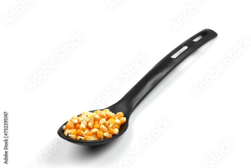 sweet corn in the black spoon an isolated on white background