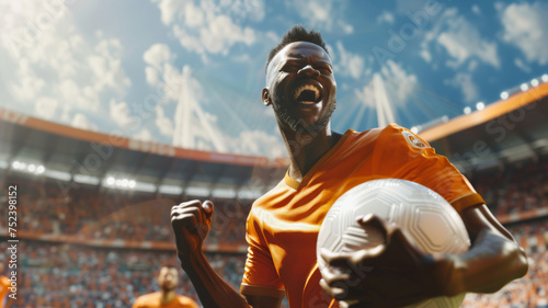 Exuberant soccer player celebrates a victory on a sunlit stadium field.