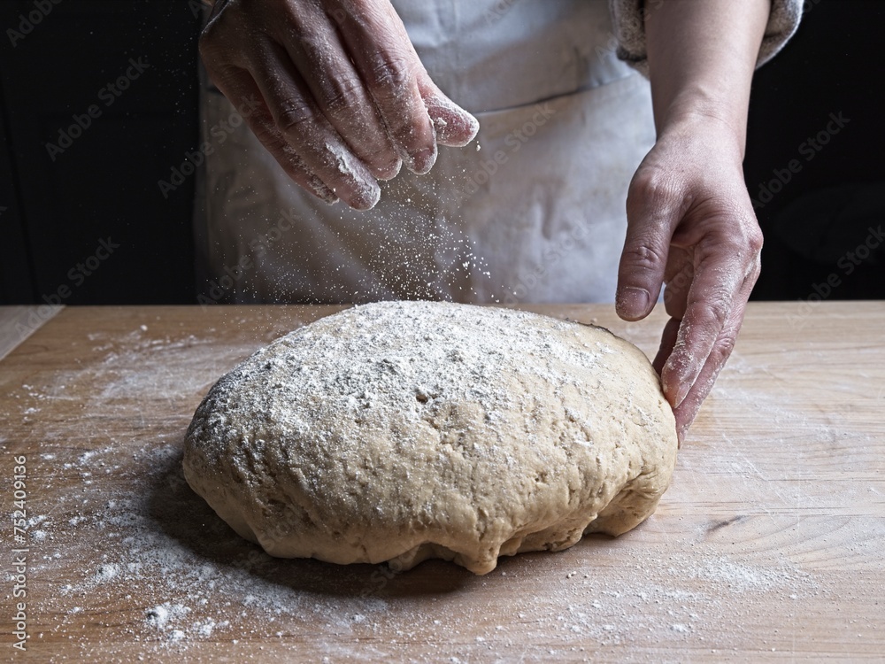 Spreading flour on ball of dough. Spreading flour on ball of dough.