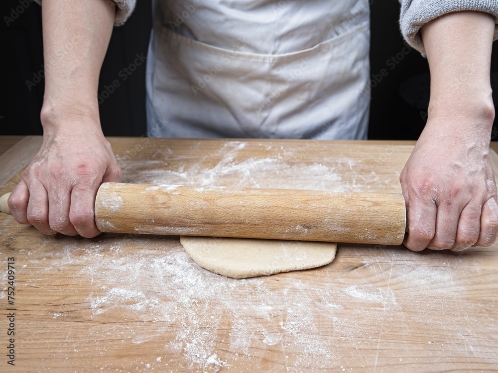 Rolling out dough with a pin. Rolling out dough with a pin.