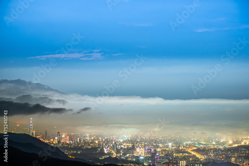 Rolling clouds and city lights enrich the night scene. Enjoy the night view of Taipei City from the mountain. Taiwan