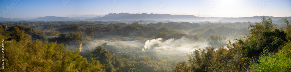 In the morning, smoke curls up from the valley and the bamboo forest is green. The Erliao tribe in Zuozhen enjoys the sunrise landscape, Tainan City, Taiwan.