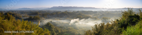 In the morning, smoke curls up from the valley and the bamboo forest is green. The Erliao tribe in Zuozhen enjoys the sunrise landscape, Tainan City, Taiwan. photo