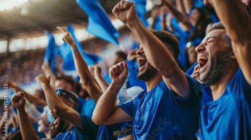 Group of people with blue shirts cheering on their soccer team with blue flags in the stadium in high resolution and high quality. football  sports concept