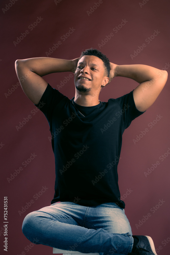 Portrait of young African American man with arms open and smiling