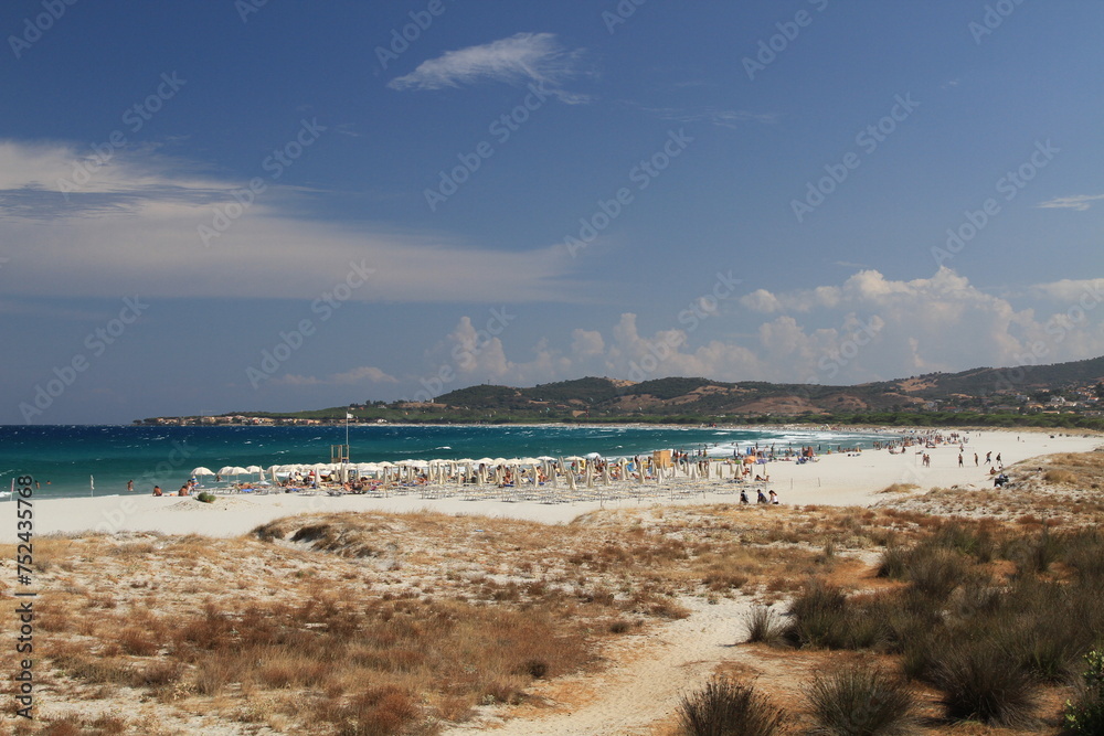 Turquoise sea water , white sand and blue sky in the beautiful beach of La Caletta, Siniscola in Sardinia, Italy