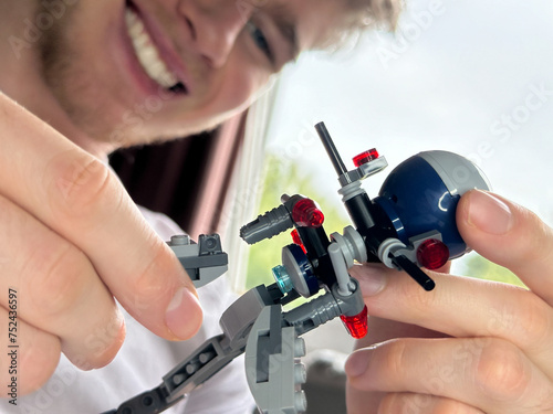 Selective focus on constructor toy happy man is putting together