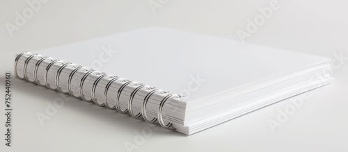 Blank white notebook with spiral binding for writing thoughts and ideas