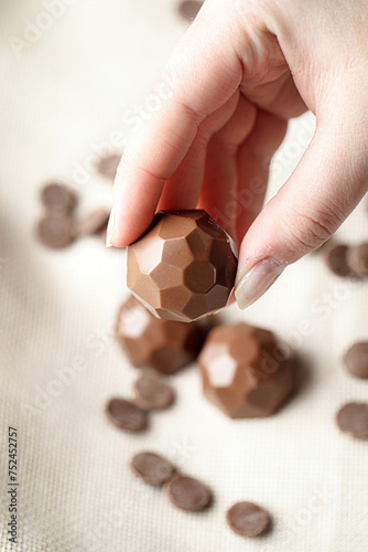 Person Holding a Chocolate Ball in Their Hand