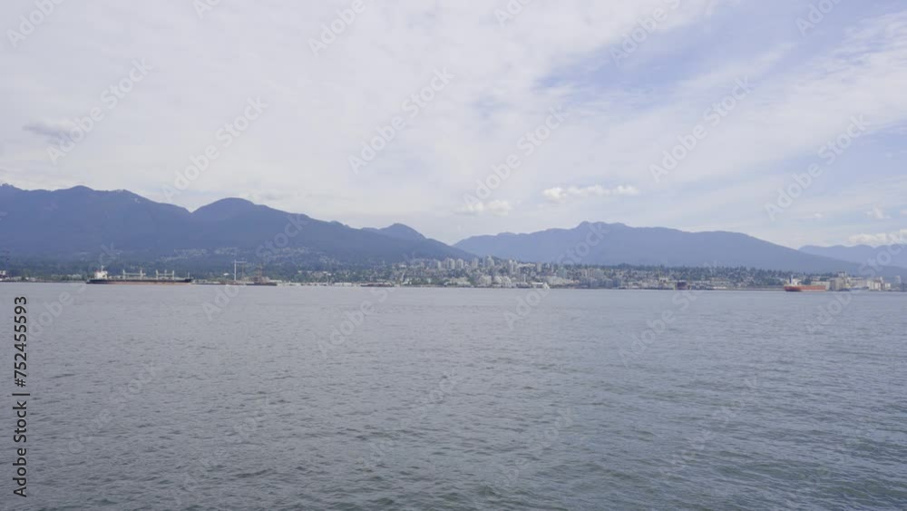 A 4k slow-motion video of North Vancouver and the mountains in the background as viewed from Vancouver Harbour. A 4k slow-motion video of North Vancouver and the mountains in the background as viewed from Vancouver Harbour.